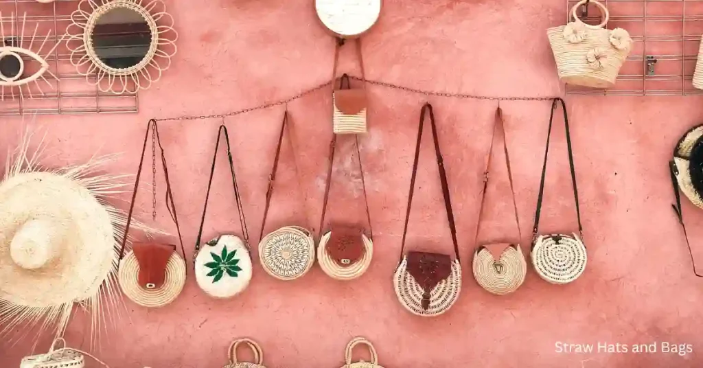 Traditional straw hats and bags hanging at a souvenir stall.